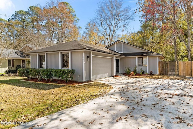 ranch-style house featuring a garage and a front yard