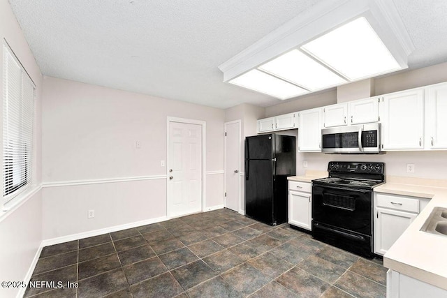 kitchen featuring white cabinetry, black appliances, and a textured ceiling