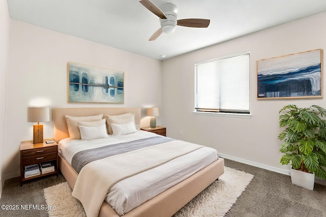 bedroom with ceiling fan and dark colored carpet