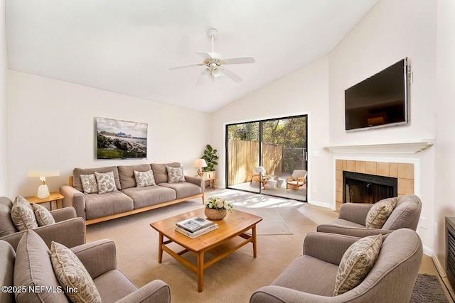 carpeted living room with ceiling fan, a fireplace, and high vaulted ceiling