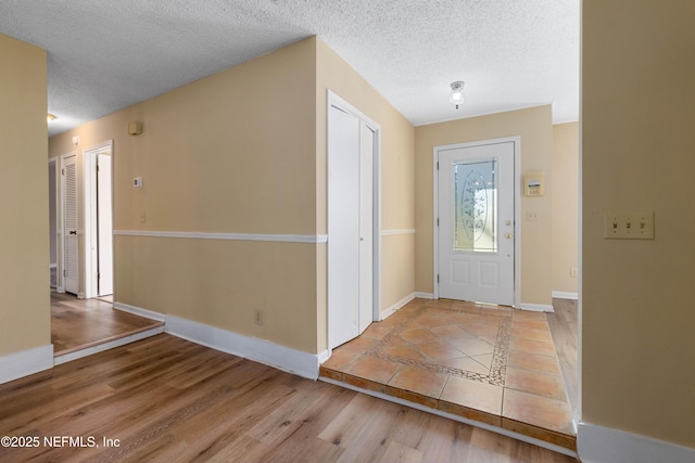 entrance foyer featuring light hardwood / wood-style flooring and a textured ceiling