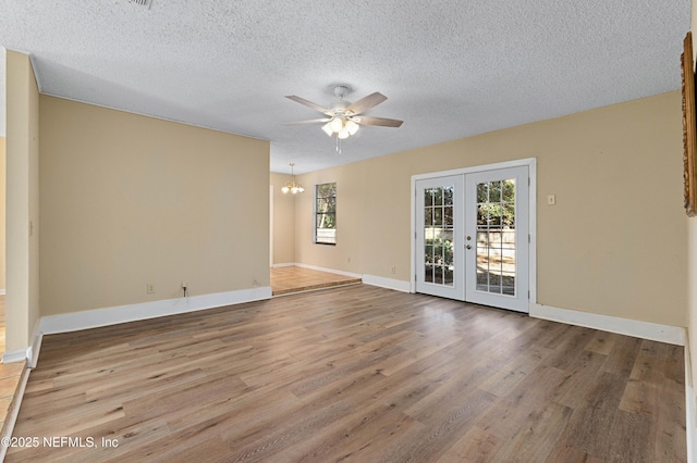 unfurnished room featuring hardwood / wood-style flooring, a textured ceiling, ceiling fan, and french doors