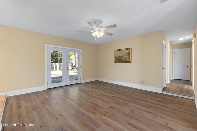 empty room with hardwood / wood-style floors, french doors, a textured ceiling, and ceiling fan