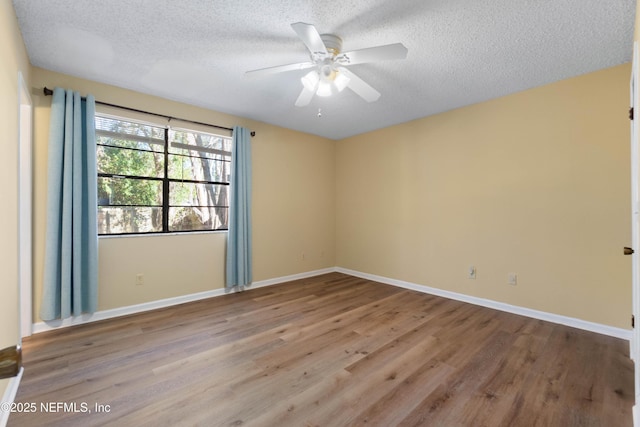 unfurnished room featuring ceiling fan, a textured ceiling, and light wood-type flooring