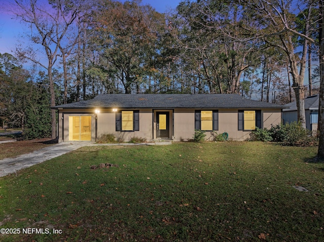 single story home with a garage and a lawn