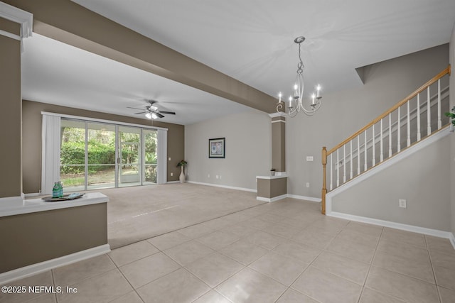 unfurnished living room with decorative columns, ceiling fan with notable chandelier, and light carpet