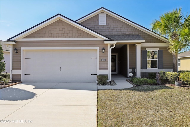 view of front of property featuring a garage and a front yard