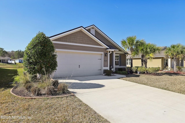 view of front of house featuring a garage and a front lawn