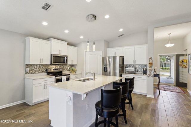 kitchen featuring appliances with stainless steel finishes, sink, and white cabinets