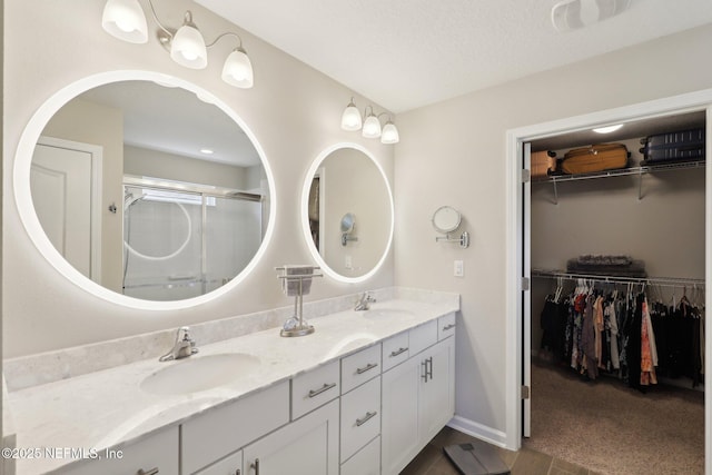 bathroom featuring vanity and an enclosed shower