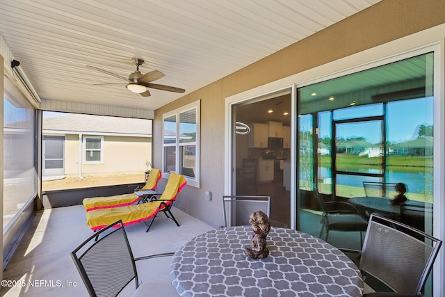 sunroom / solarium featuring ceiling fan and a wealth of natural light