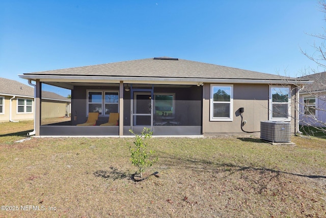 rear view of property featuring a sunroom and a yard