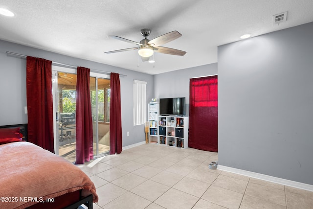 bedroom featuring a textured ceiling, access to outside, light tile patterned flooring, and baseboards