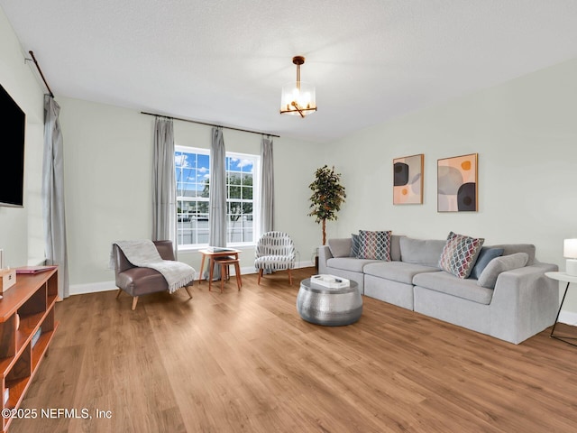 living room featuring a textured ceiling and light wood-type flooring