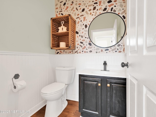 bathroom featuring vanity, wood-type flooring, and toilet