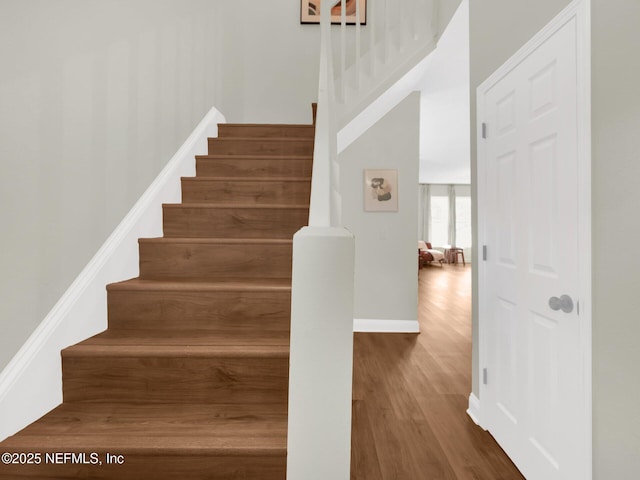 stairs featuring hardwood / wood-style flooring