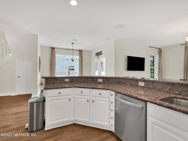 kitchen with white cabinetry, dishwasher, pendant lighting, and dark stone countertops