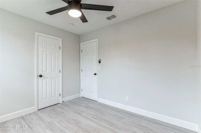 spare room featuring ceiling fan and light wood-type flooring