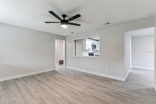 unfurnished living room featuring ceiling fan, light hardwood / wood-style flooring, and a textured ceiling