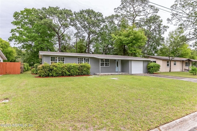 ranch-style home featuring a garage and a front lawn