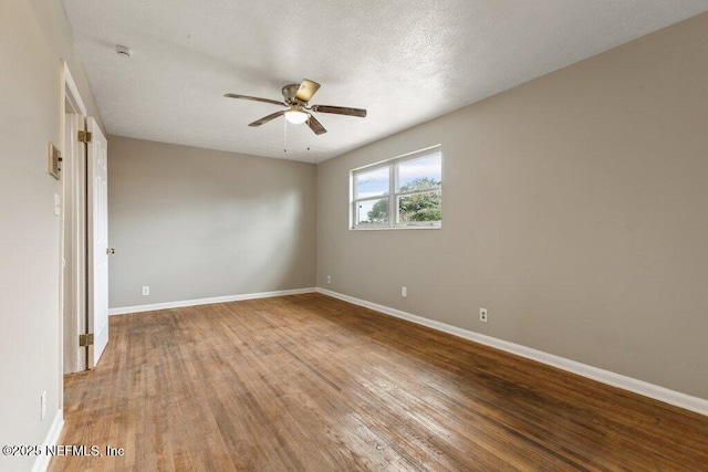 empty room featuring ceiling fan, a textured ceiling, and light wood-type flooring