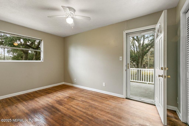 spare room with hardwood / wood-style flooring and ceiling fan