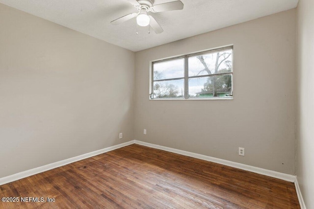 spare room featuring hardwood / wood-style flooring and ceiling fan