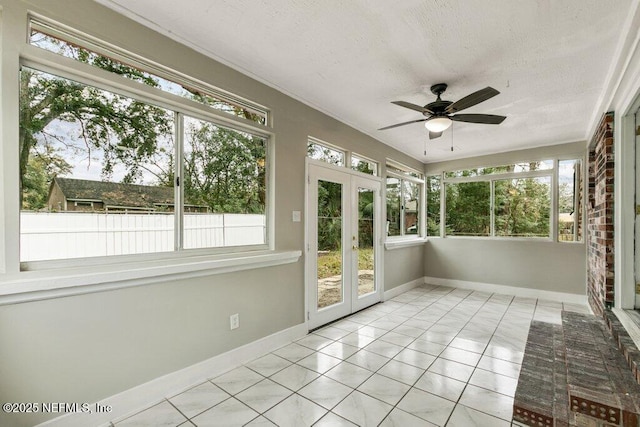 unfurnished sunroom featuring french doors and ceiling fan