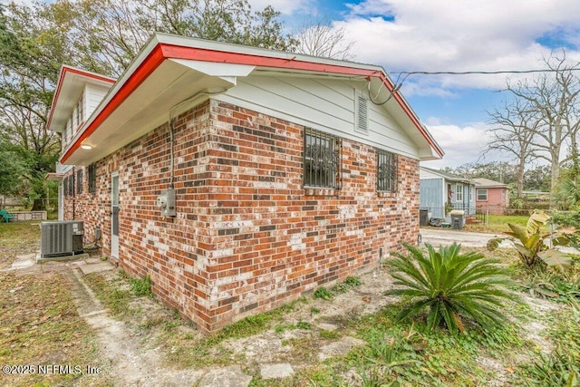 view of side of property featuring central AC