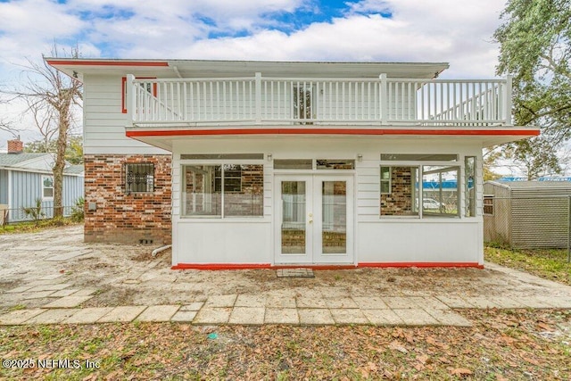 back of property with a patio, a balcony, and french doors