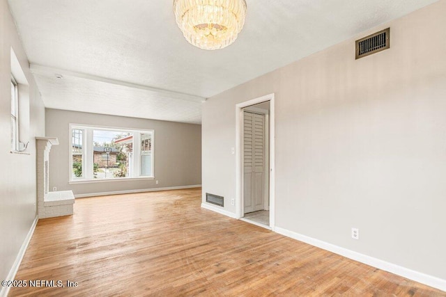 interior space featuring an inviting chandelier and light wood-type flooring