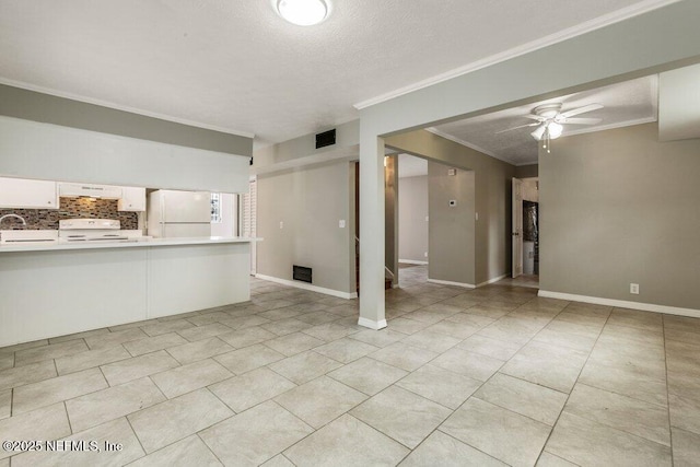 unfurnished living room featuring sink, crown molding, light tile patterned floors, ceiling fan, and a textured ceiling