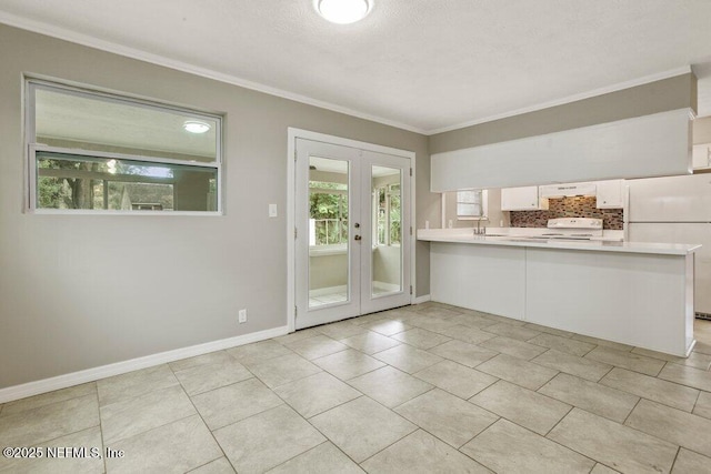 doorway with light tile patterned floors, sink, ornamental molding, and french doors