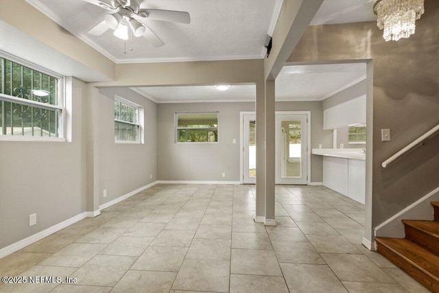 tiled entryway with ceiling fan with notable chandelier and ornamental molding