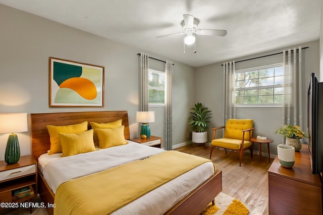 bedroom with hardwood / wood-style floors and ceiling fan