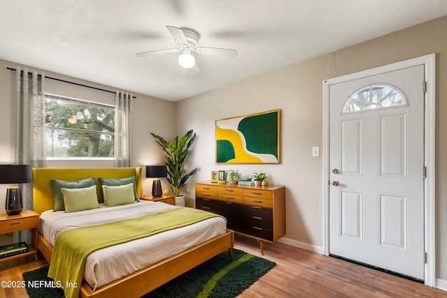 bedroom with hardwood / wood-style flooring and ceiling fan