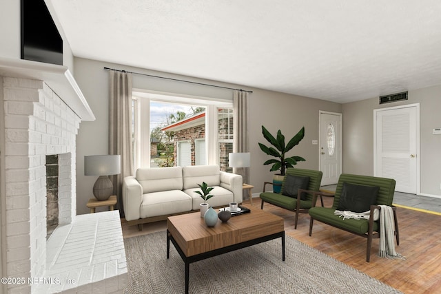 living room featuring hardwood / wood-style floors and a fireplace