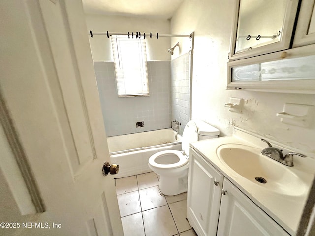 full bathroom featuring vanity, tile patterned floors, toilet, and tiled shower / bath