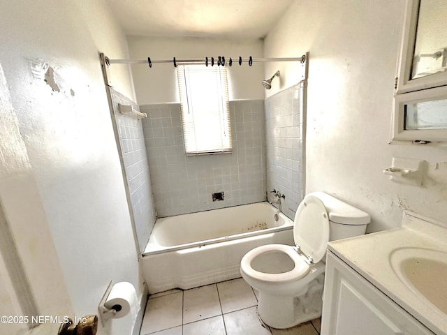 full bathroom featuring tiled shower / bath, vanity, toilet, and tile patterned flooring