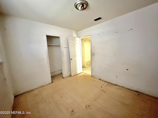 unfurnished bedroom with a closet