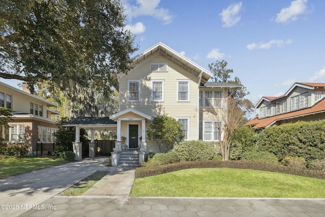 view of property featuring a carport and a front yard