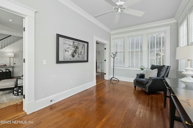 sitting room with ornamental molding, dark hardwood / wood-style floors, and ceiling fan