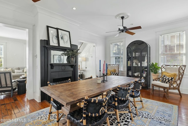 dining space featuring hardwood / wood-style flooring, ornamental molding, and ceiling fan