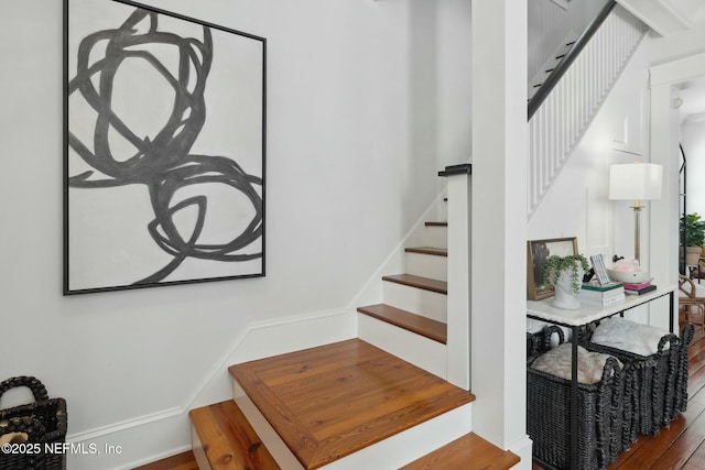 staircase with wood-type flooring