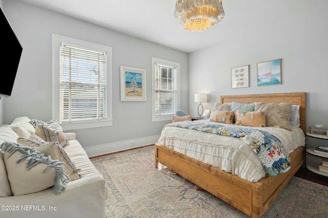 bedroom with wood-type flooring and multiple windows