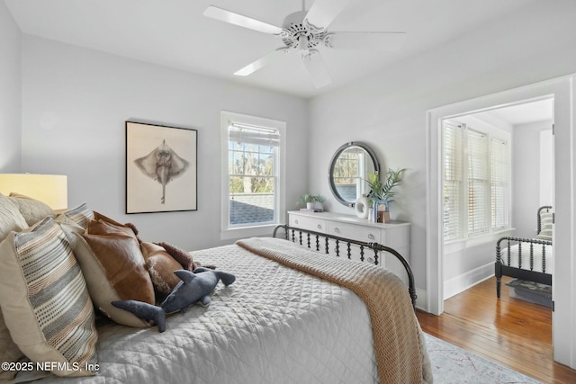 bedroom with hardwood / wood-style floors and ceiling fan