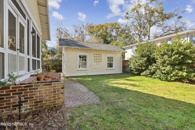 exterior space with a patio, an outdoor structure, and a lawn