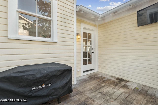 view of exterior entry with a wooden deck