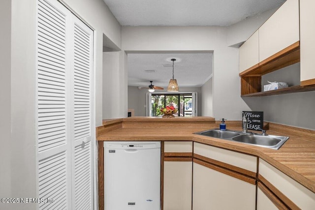 kitchen with white cabinets, dishwasher, decorative light fixtures, open shelves, and a sink