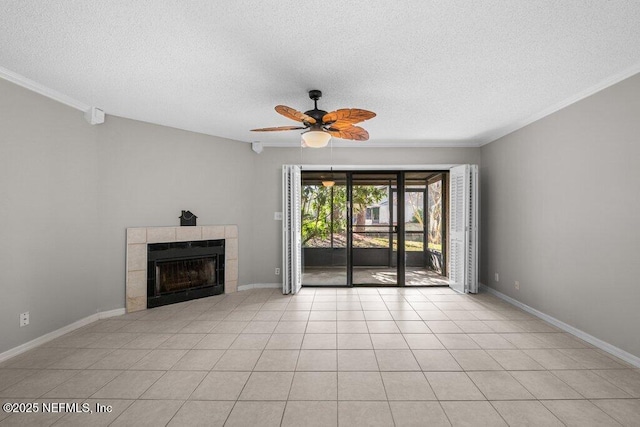 unfurnished living room with a textured ceiling, ceiling fan, a fireplace, and baseboards